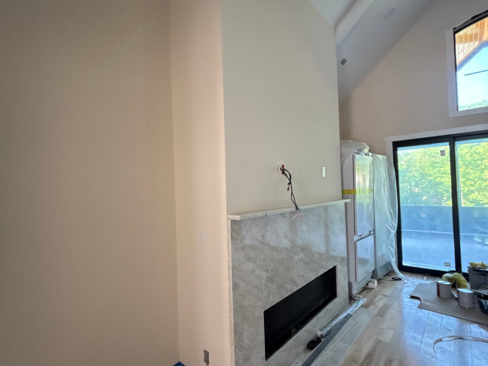 Bare fireplace wall before slat panels were installed