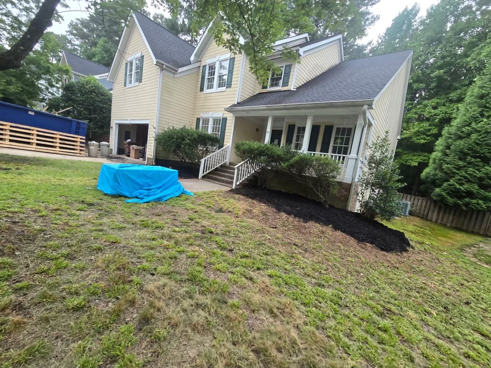 Freshly mulched planting beds and cleared front yard at a Raleigh home