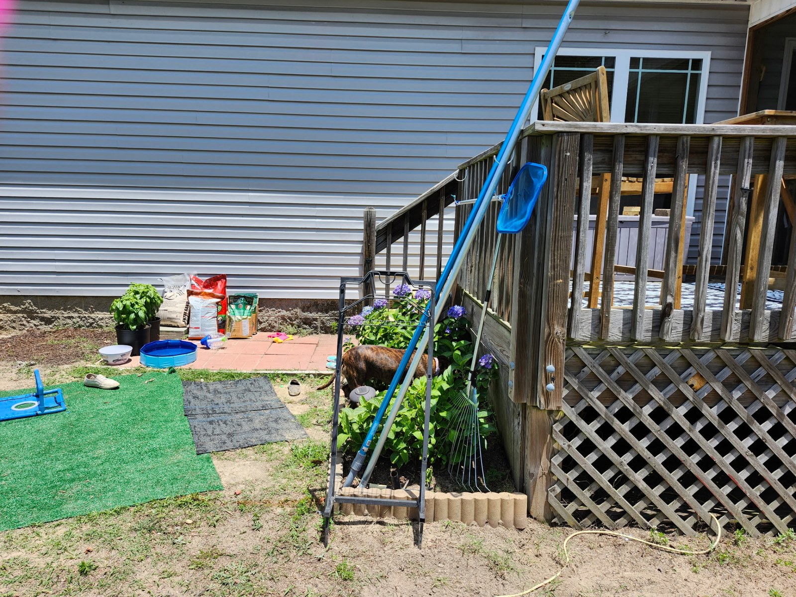Backyard with aging weathered deck and stairs before the pool deck addition